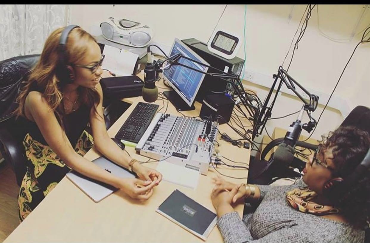 DK Jonah in conversation across a radio studio desk